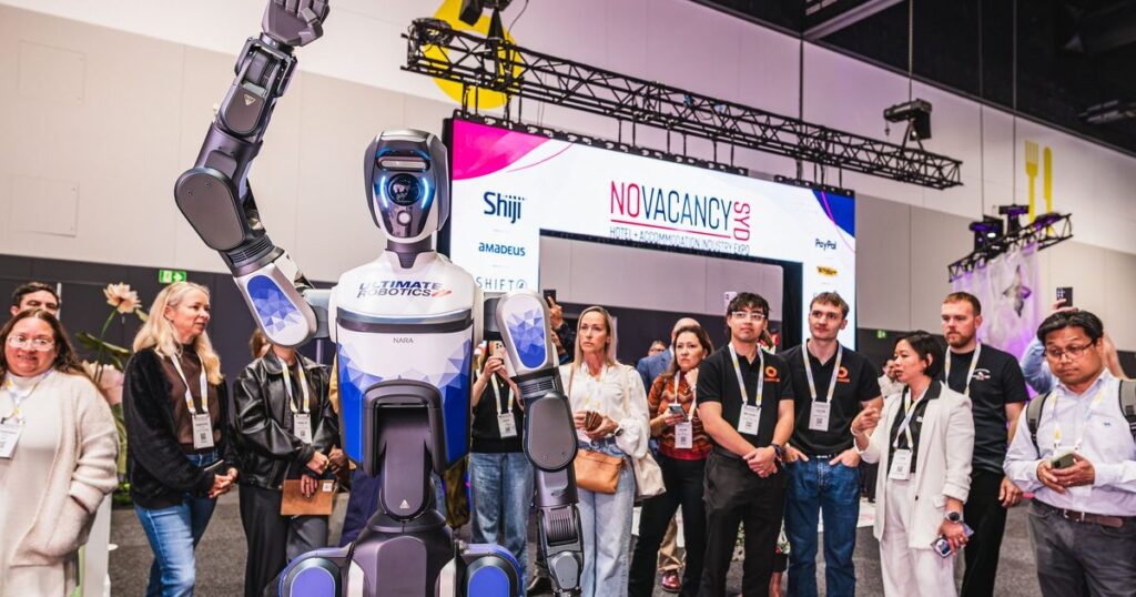 Visitors watching a hospitality robot demonstration at the No Vacancy hotel and accommodation expo in Sydney